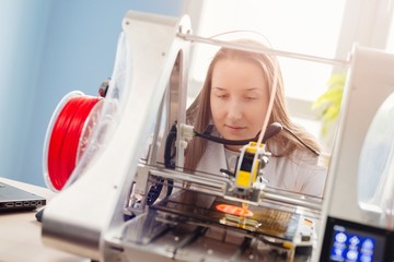 Woman working with 3d printer
