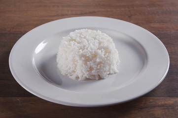 White rice in plate on wooden table
