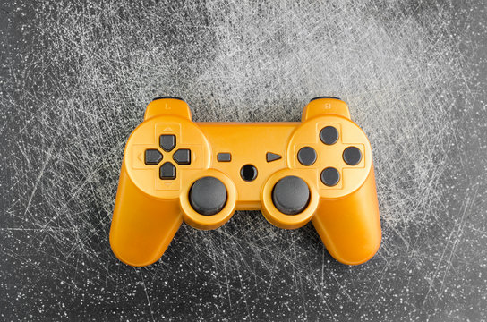 Orange Gaming Joystick On Dark Scratched Background