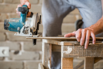 a man working with manual electric saw