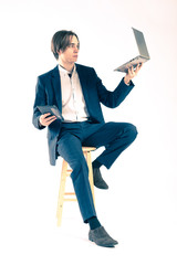 Man on the stool with laptop and tablet