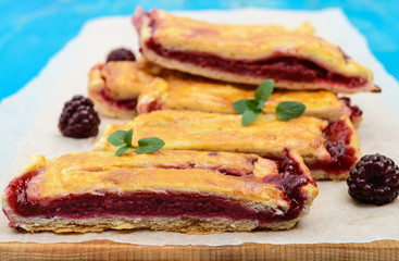 Slices of sweet berry pie on a blue background.