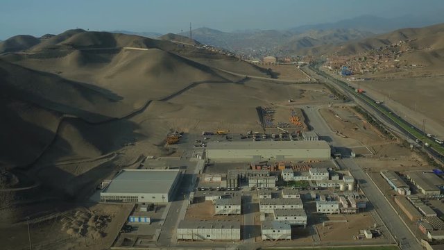 Ventanilla Peru Aerial v16 Flying low over oil refinery panning with downtown views in distance.