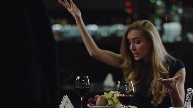 woman arguing with man in restaurant