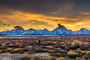Sunset at Grand Teton National Park. Beautiful snow-capped mountains. Golden autumn. © khomlyak