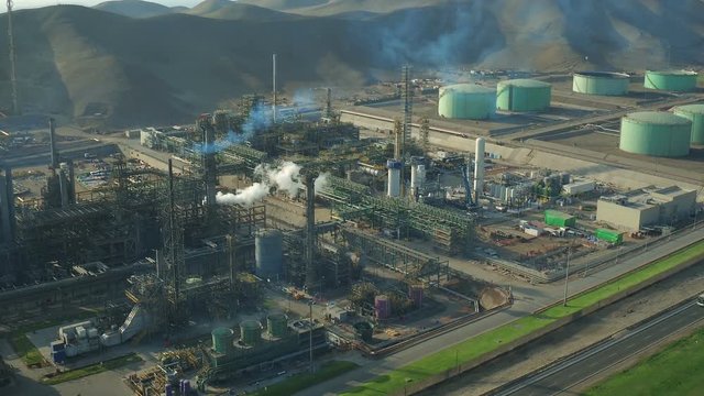 Ventanilla Peru Aerial v19 Flying low over oil refinery panning down vertically.