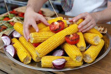 Fresh corncobs cooked at barbecue grill