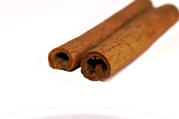 Closeup of cinnamon sticks on a white background