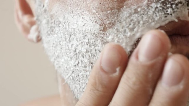 Preparing face with shave foam close-up applying slow motion 1920 X1080 HD footage - Caucasian male hand spreads shaving gel on beard and cheeks slow-mo 1080p FullHD video 