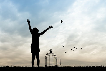 girl and bird cage at sunset