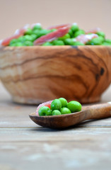 DISH OF WOOD FULL OF PEAS WITH HAM