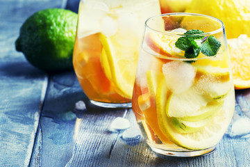 White sangria with fruit and ice, gray-silver background, selective focus
