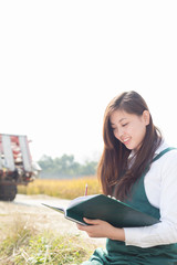 young asian woman agronomist in golden field