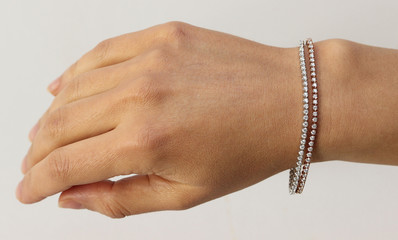 Bracelet on woman hand on white