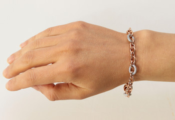 Bracelet on woman hand on white