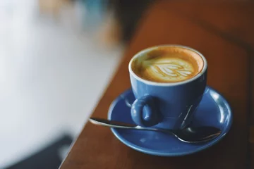 Zelfklevend Fotobehang coffee latte in coffee shop © chayathon2000