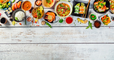 Asian food served on wooden table, top view, space for text