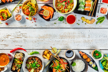 Asian food served on wooden table, top view, space for text