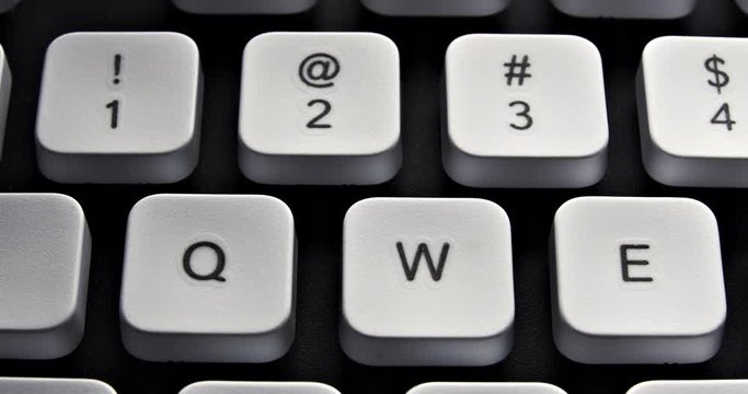 English PC keyboard keys macro. Slow sliding from Tab along QWERTY and numeric key rows. Contrast color.