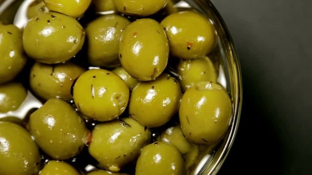Olives in olive oil. video rotation
