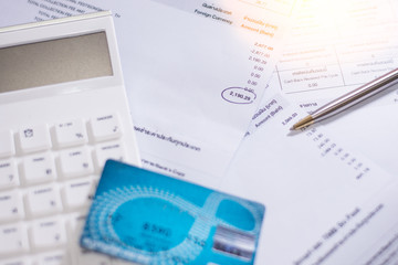 Bill finance and calculator with pen and credit card