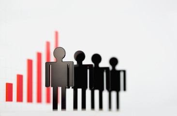 Silhouettes of business people located on the background of infographics. The image depth of field