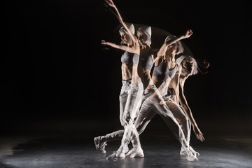 woman in sports clothing dancing on black