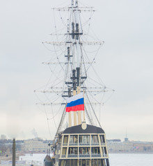 vintage sailboat with a Russian flag on the mast.