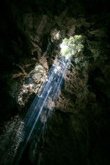 Fototapeta na wymiar Light rays illuminating a cave in Vietnam