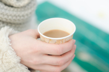 Fototapeta na wymiar Hand holding coffee cup, outdoors