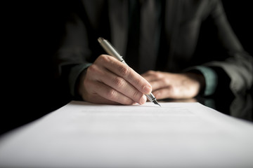 Closeup of lawyer or executive signing a contract - obrazy, fototapety, plakaty