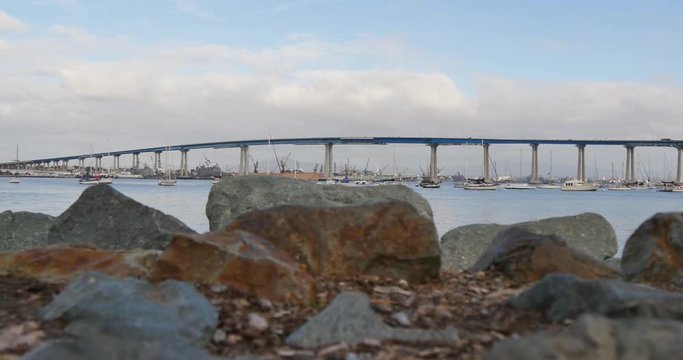 A low angle slow dolly establishing shot of Coronado Bridge between San Diego and Coronado Island.  	