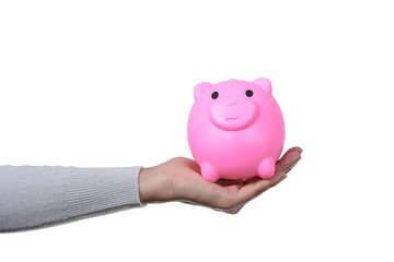 Female holding a pink piggy bank isolated