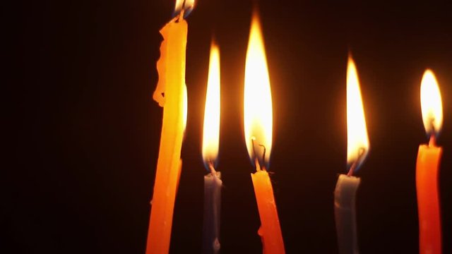 Close-up of colored candles burning fuse