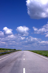 Fototapeta premium Asphalt road over blue sky background. 