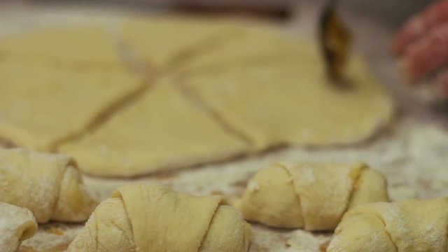 Woman working with dough. making homemade croissants