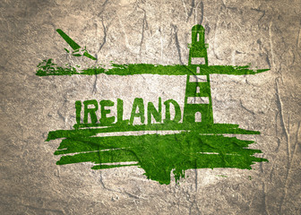 Lighthouse on brush stroke seashore. Clouds line with retro airplane icon. Ireland country name text. Concrete textured