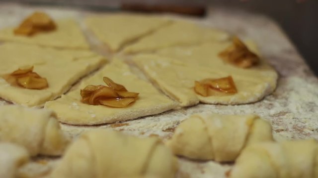 Woman working with dough. making homemade croissants