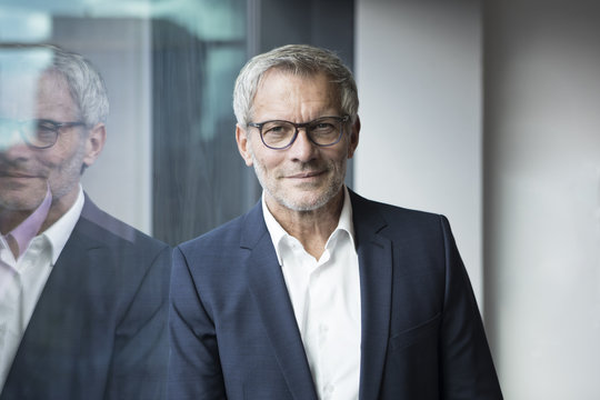 Portrait of confident businessman at the window