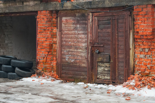 Old garage doors and tumbledown brick walls.