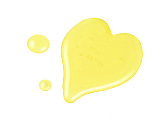 Honey drops and heart shape isolated on white background
