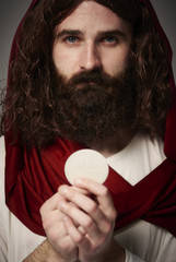 Jesus Christ holding holy Eucharist in hands