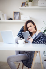 young woman reading using tablet at home