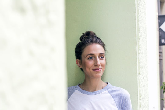 Portrait of smiling young woman with hair bun