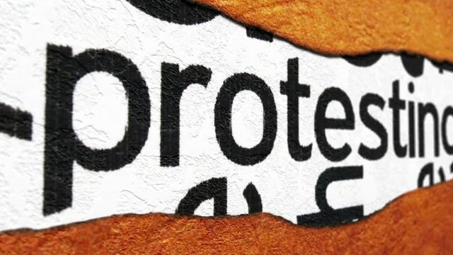 Protesting text on torn paper