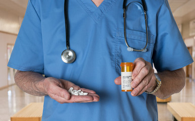 Generic oxycodone tablets in hands of doctor - this is not a trademarked drug
