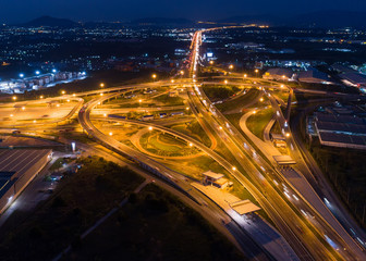 Fototapeta na wymiar Top view over the highway,expressway and motorway at night, Aerial view interchange of a city, Shot from drone,Expressway is an important infrastructure in Thailand