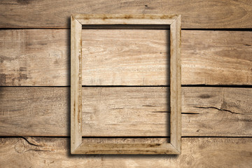 Old picture frame on wood wall.