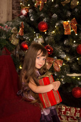 Little girl near a Christmas tree