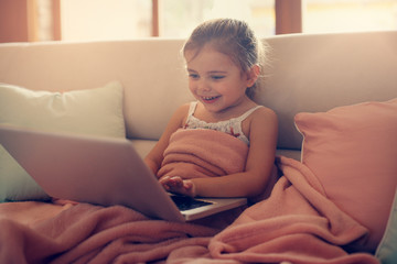 Little girl using her laptop.